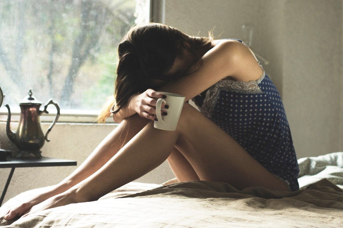 woman who woke up in the middle of sleep at night tired in the morning and drinking coffee