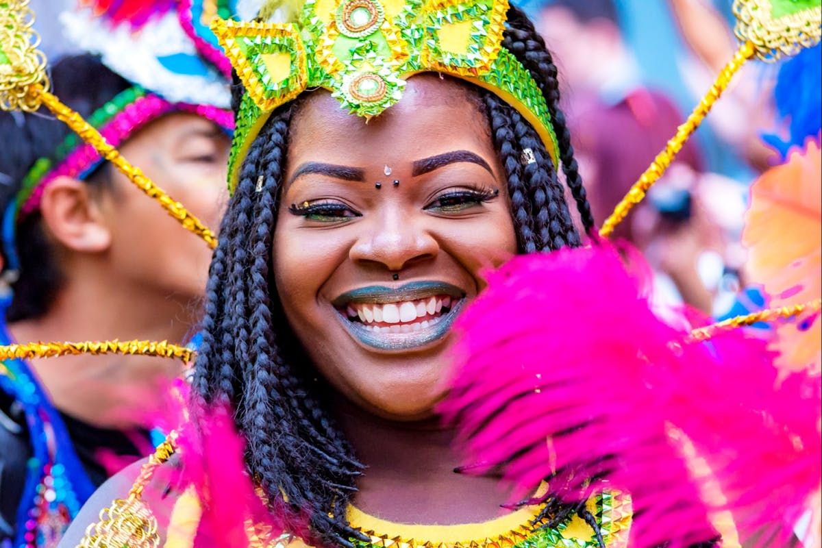 A woman smiles at Notting Hill Carnival