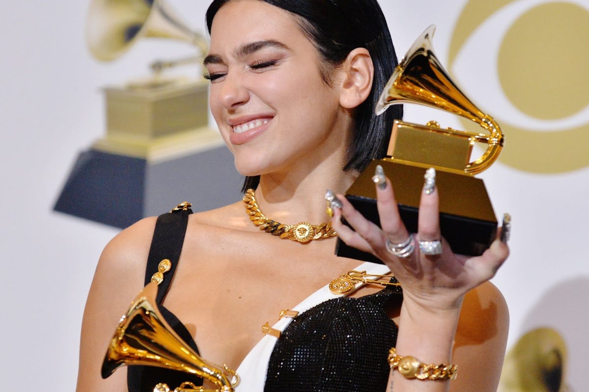 Dua Lipa holding two awards at the 2021 Grammy Awards Ceremony