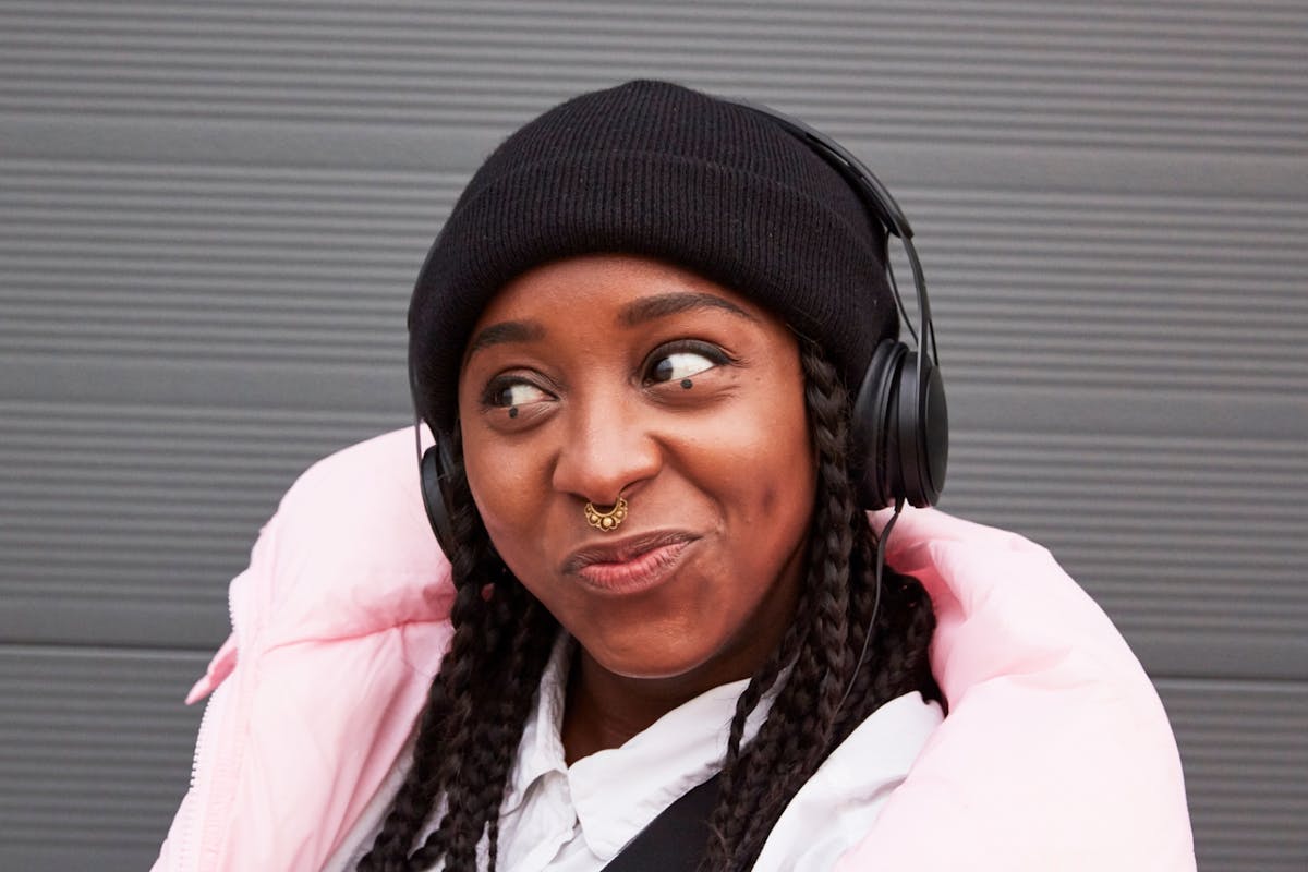 Woman listening to music through headphones
