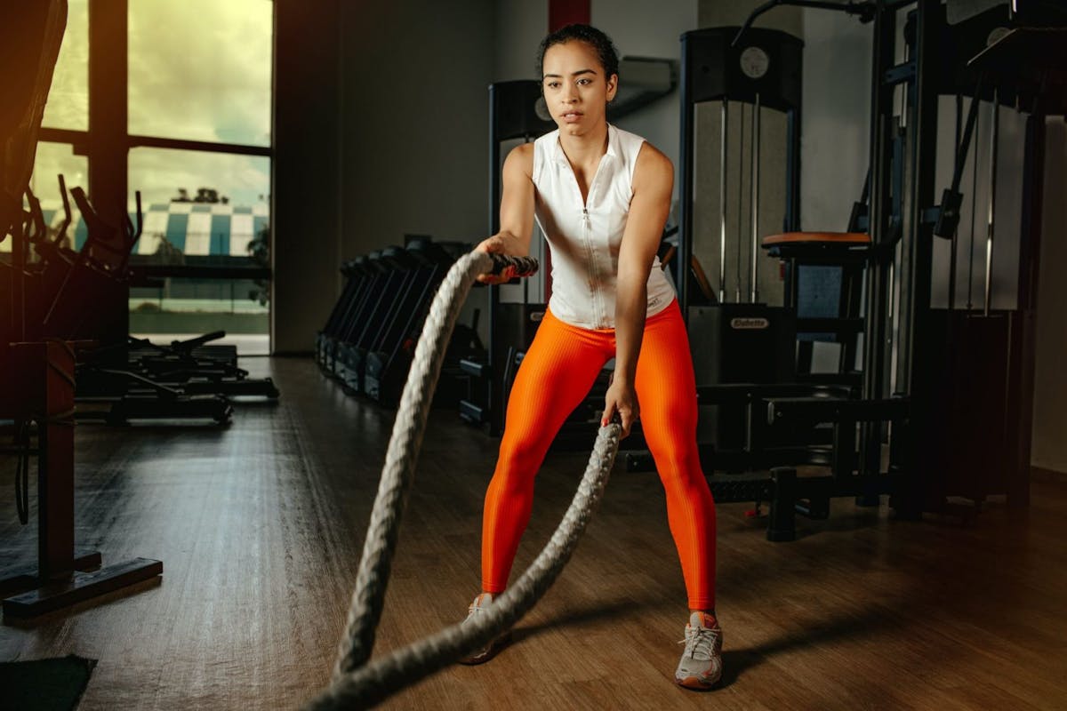 A woman doing battle ropes