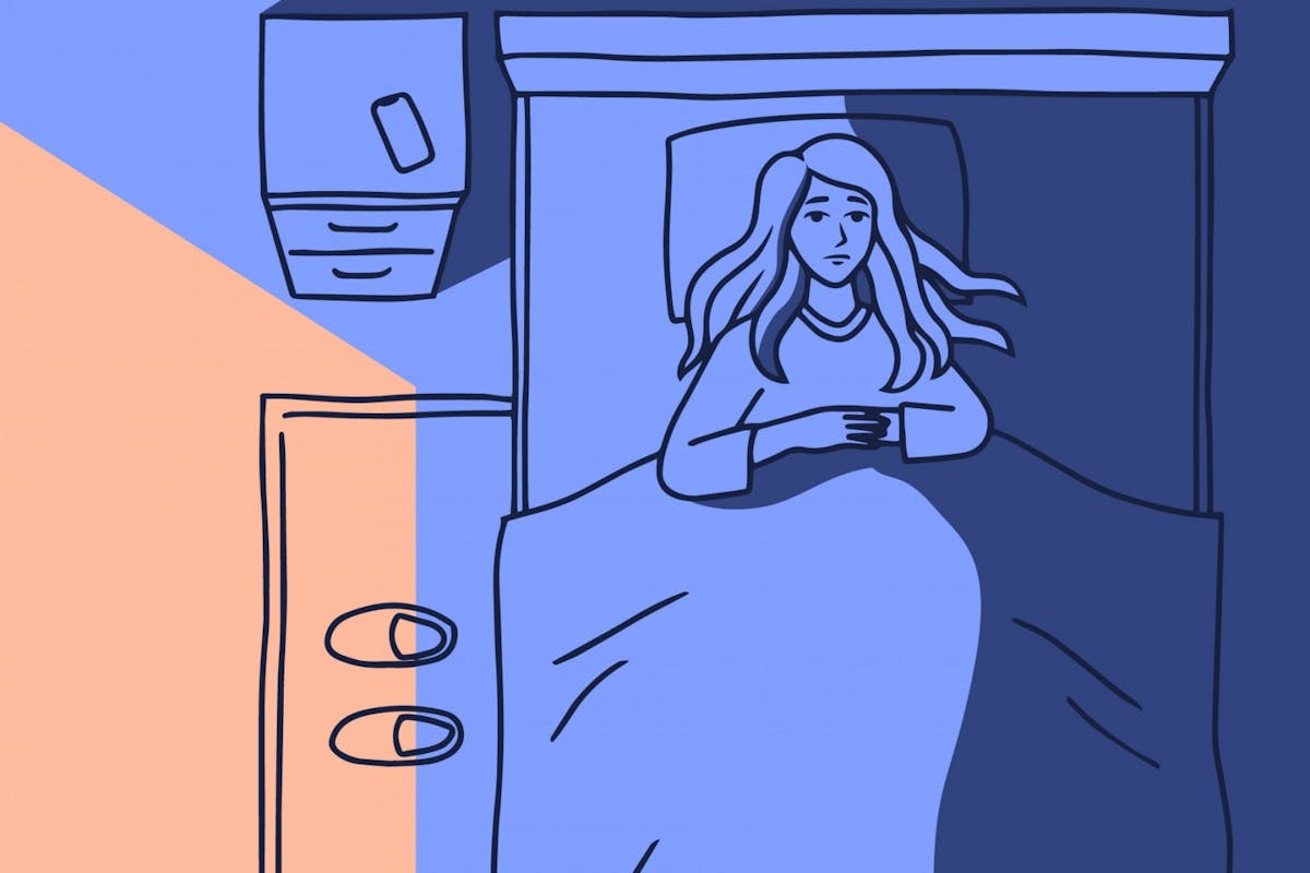 A woman lying awake in bed