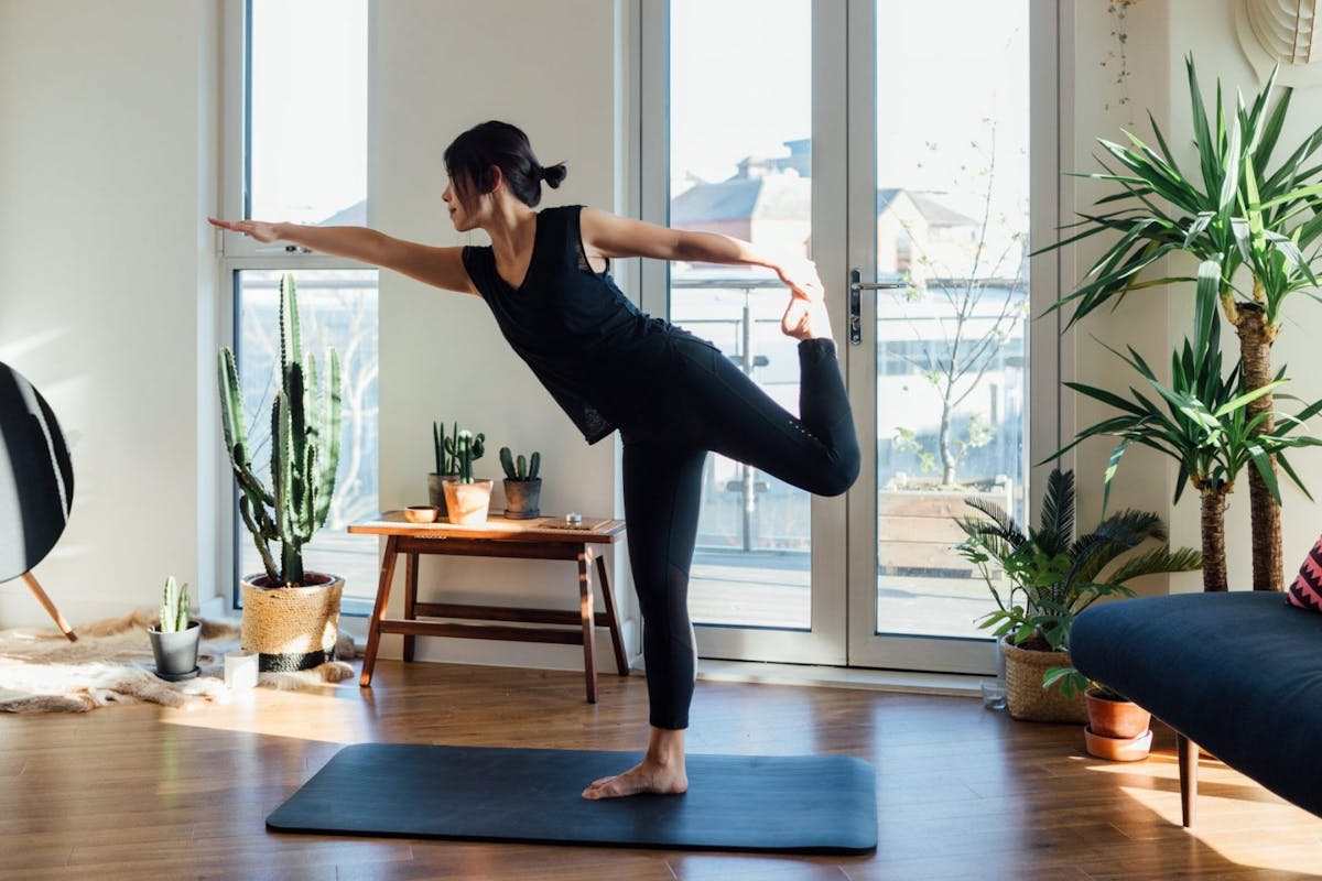 Woman doing yoga dancer pose
