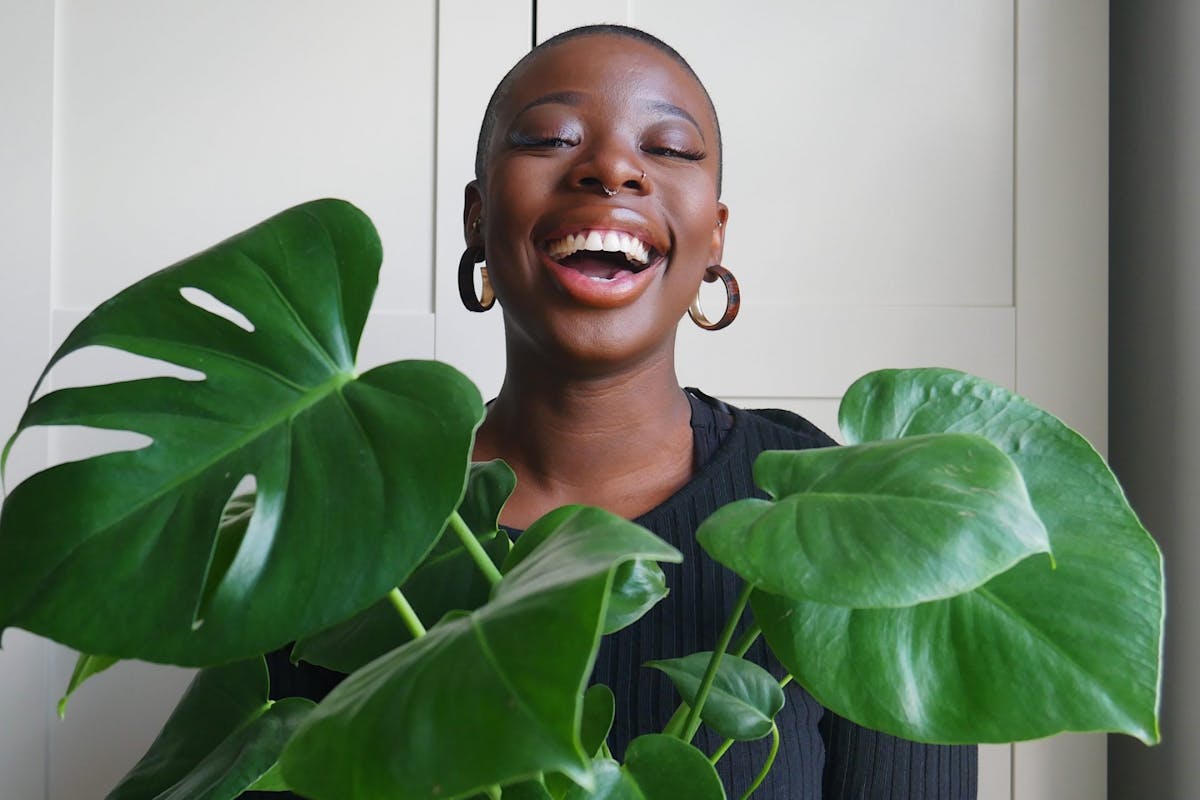 Georgette Olaiya holding a swiss cheese plant