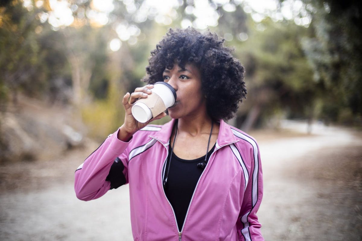 Female runner drinking coffee