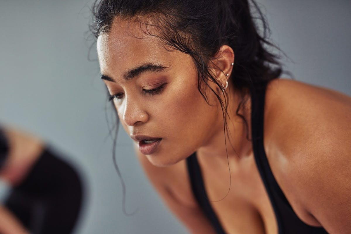 woman sweating and breathing during a workout