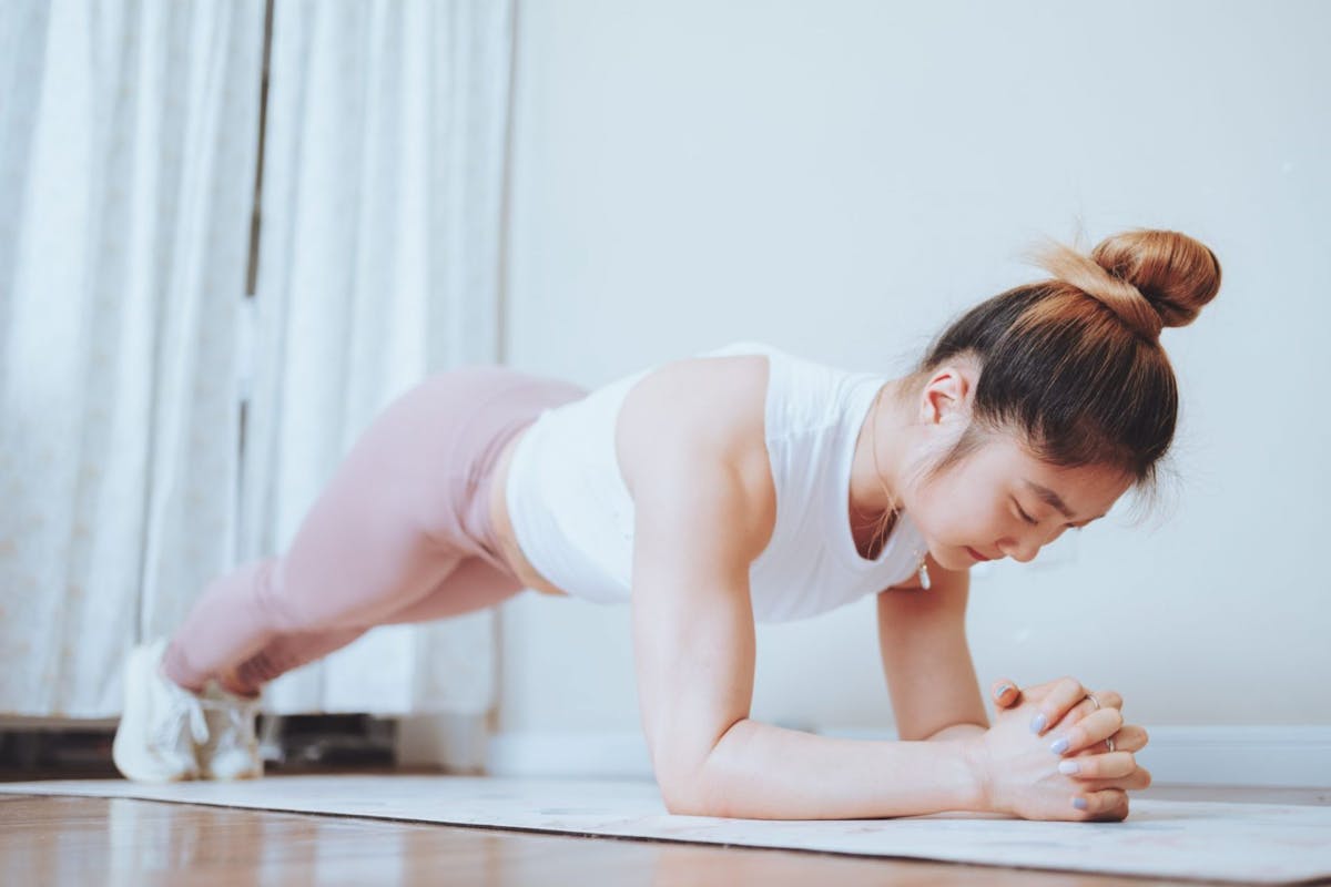 Woman holding a plank position on a yoga mat