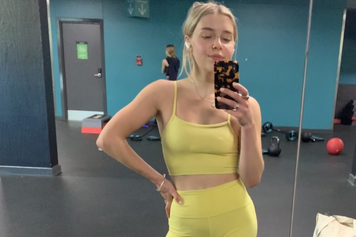 Chloe Gray alone in the gym in yellow kit