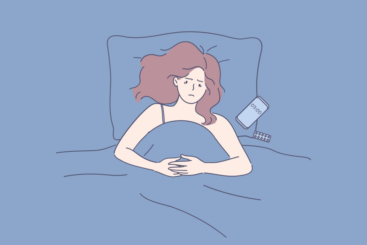 A woman awake in bed in the middle of the night