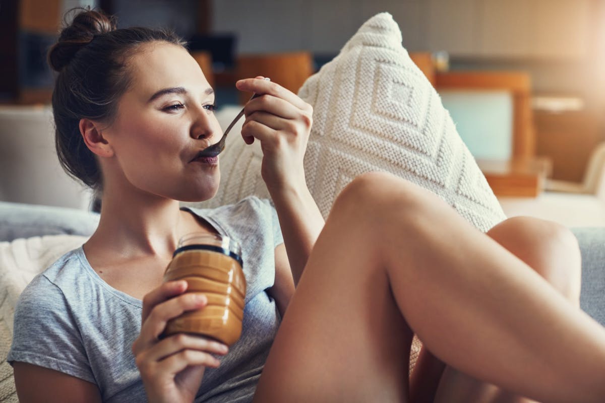 woman eating peanut butter