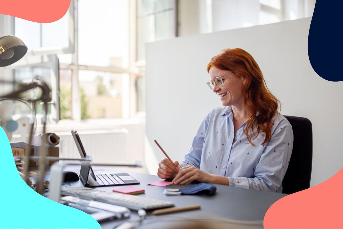 woman with red hair working at desk