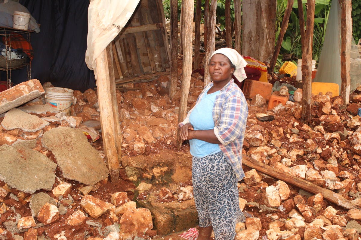 Felix Ezeline surveys the damage to her home