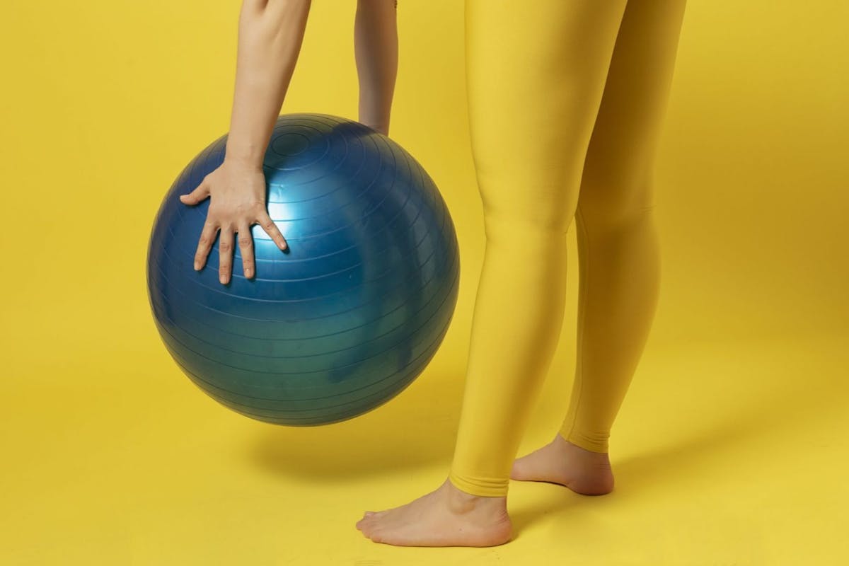 A woman holding a balance ball