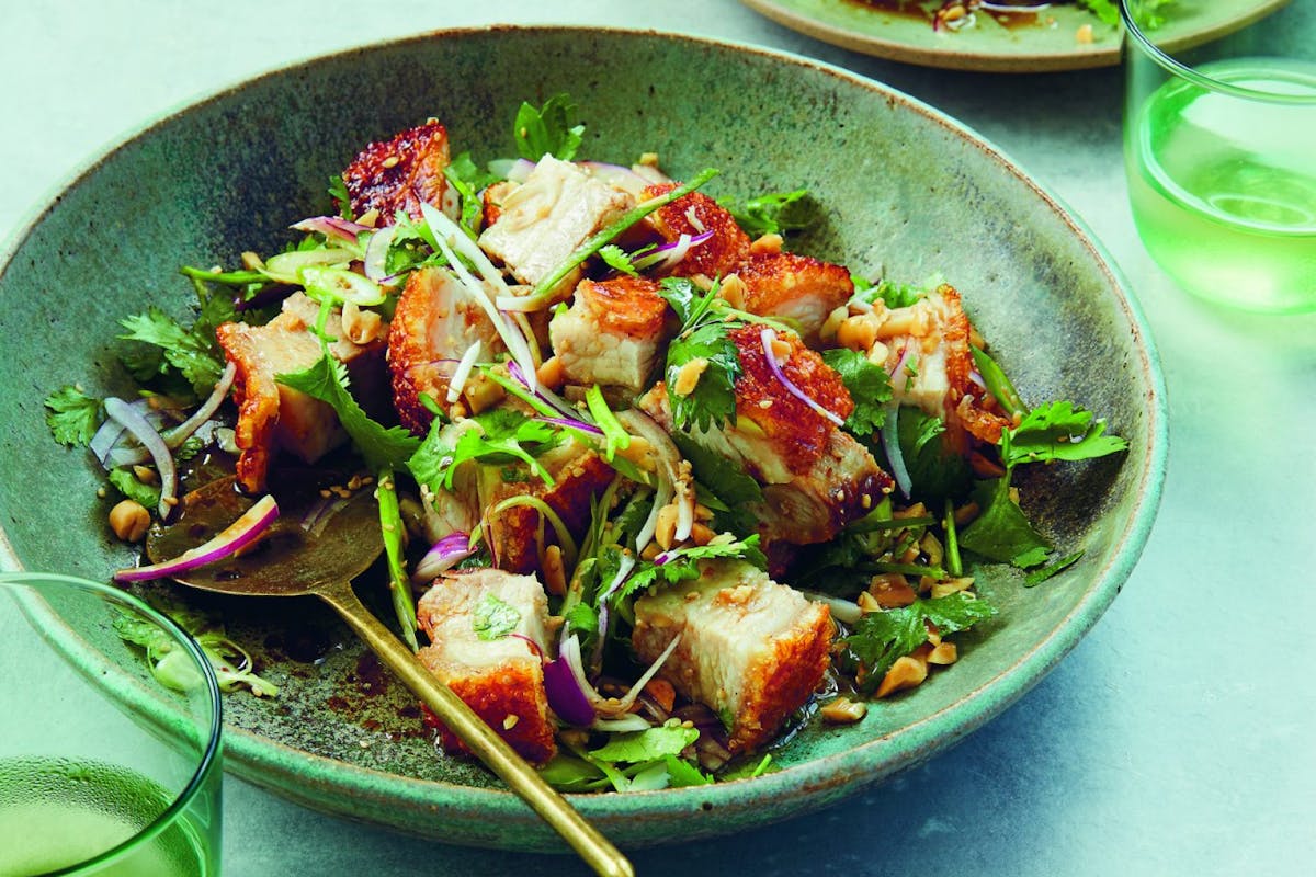 Neil Perry's Crispy pork belly with red onion, coriander, peanuts and sesame seeds