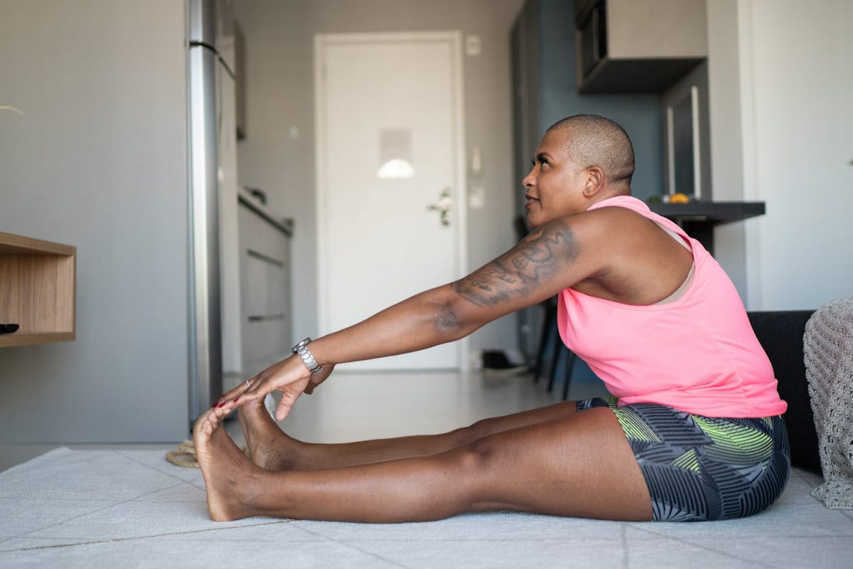A woman stretching during a home workout
