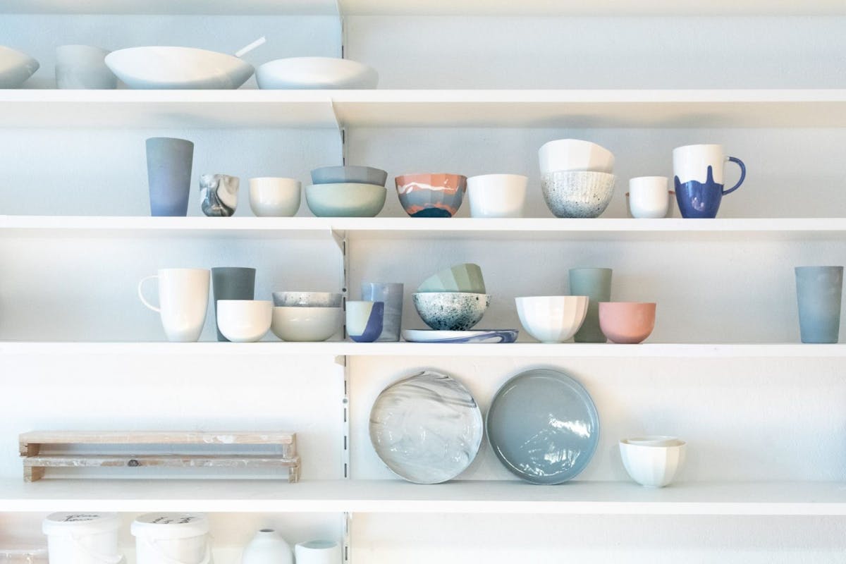 kitchen shelf organisation inspiration with pottery clay bowls and plates