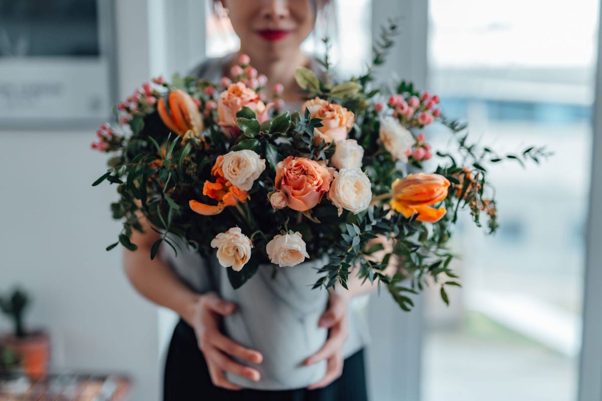 A woman holding a bunch of flowers