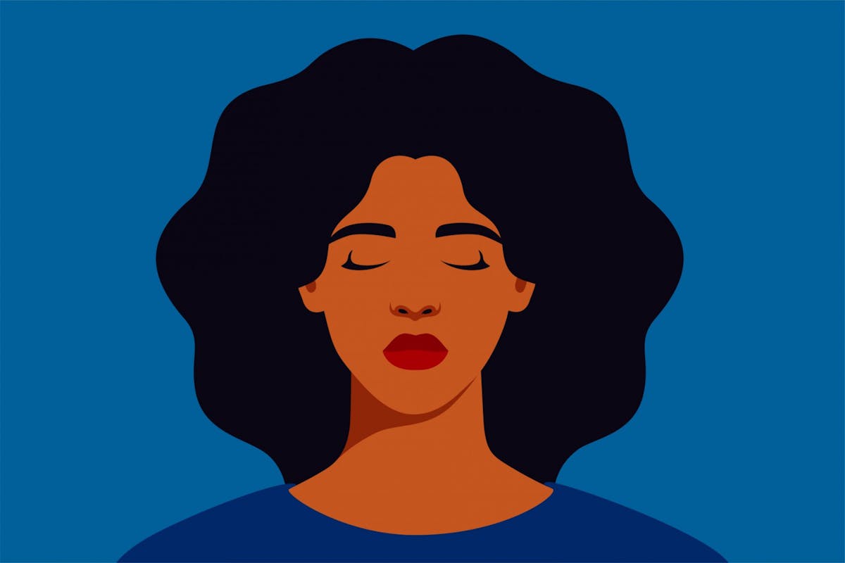 A woman sad against a blue background