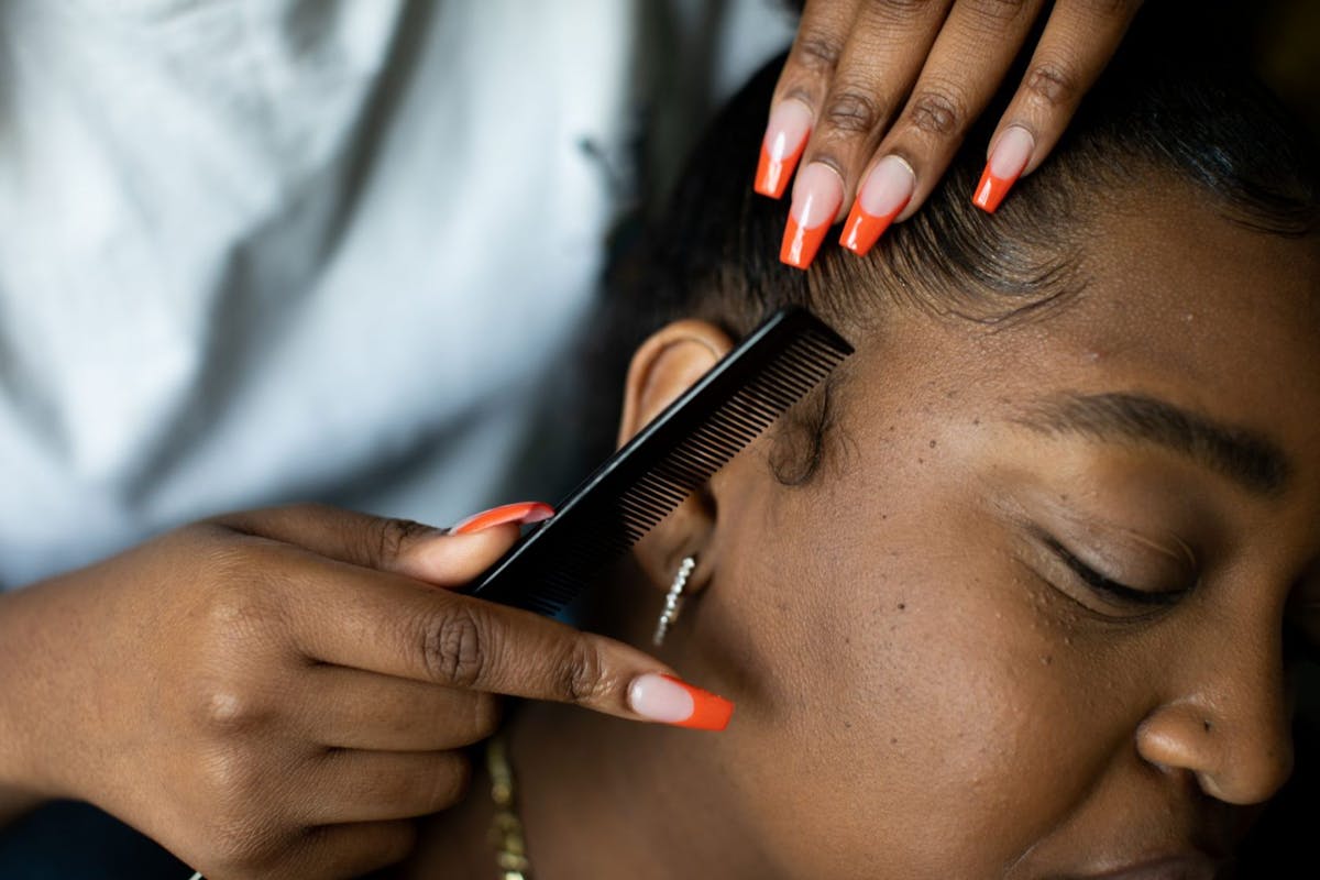 black woman having her hair done