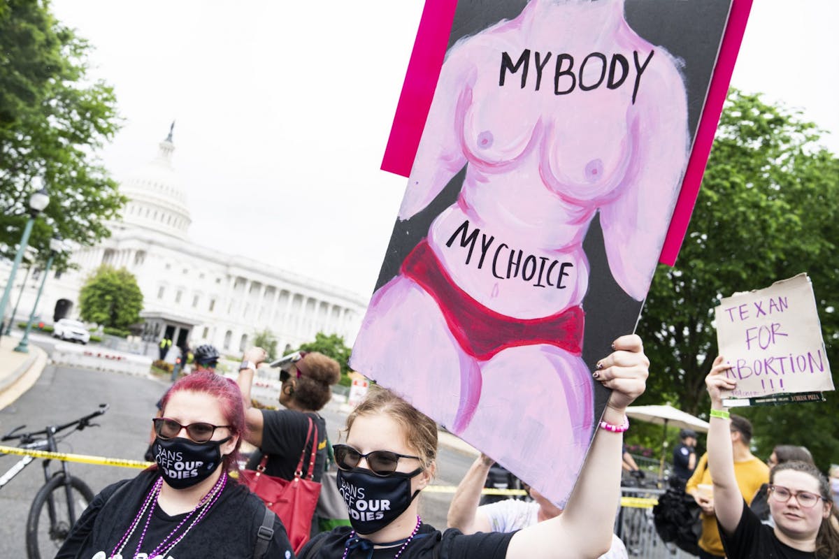 A woman holding up a sign that reads 'my body, my choice' at a pro-abortion protest in the US