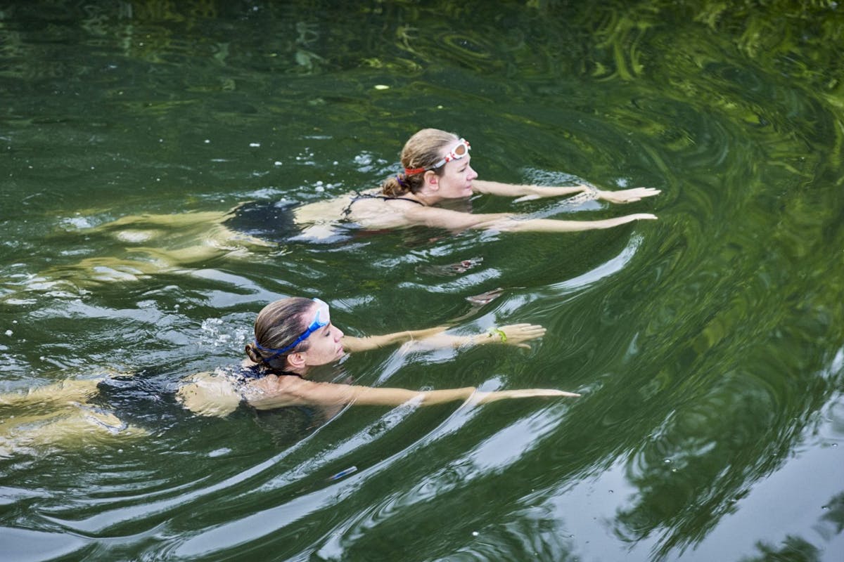 Two women swimming in a lake